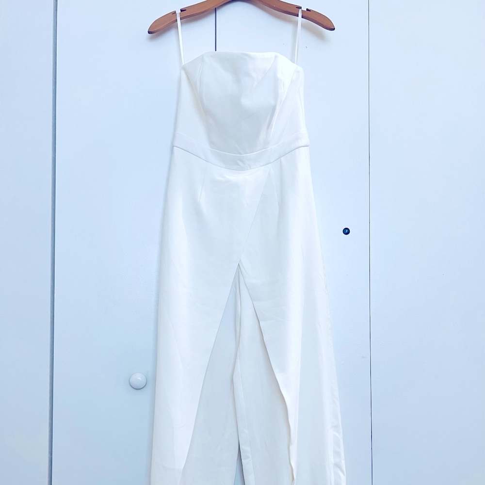 Beautiful white jump suit with strap. Very nice material